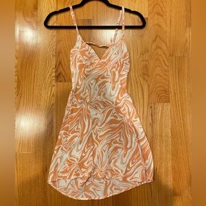 Orange swirl design mini dress. Open back with 3 straps across.